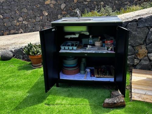 a black cabinet with a sink in a yard at Casa Rural Anton Piche with Pool-Adults Only in Granadilla de Abona