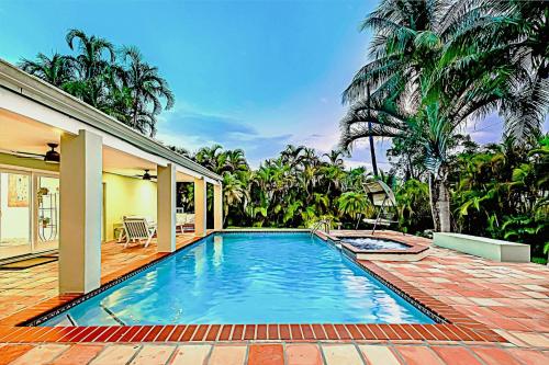 a swimming pool in the backyard of a house at Miami Dream Home/ Pool/Jacuzzi/ Fire Pit in Miami