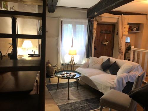 a living room with a couch and a table at Gîte de la source in Sainte-Marie-de-Vaux
