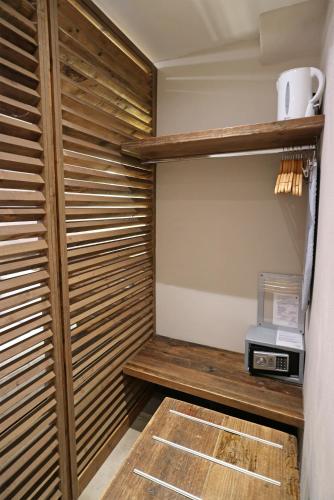 a walk in closet with wooden shelving at Allo Scalo Dei Mille in Riomaggiore