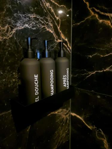 a group of three bottles sitting on top of a counter at Suite with private Jacuzzi in Saint-Louis-du-Rhône