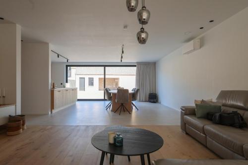 a living room with a couch and a table at luxurious home in Oud-Turnhout