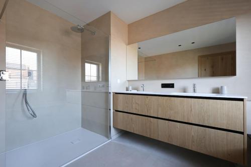 a large bathroom with a shower and a sink at luxurious home in Oud-Turnhout