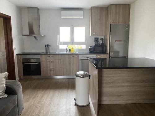 a kitchen with a trash can in the middle of a room at Casa Candido in Aboim