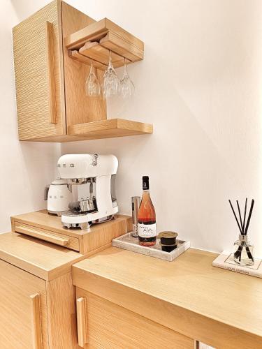 a kitchen with a mixer and a bottle of wine at DelMar Suites Syros in Finikas