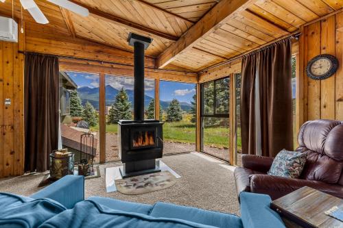 a living room with a fireplace in a house at Rustic Mountain Chalet with Private Studio Minutes from Snowbowl in Flagstaff