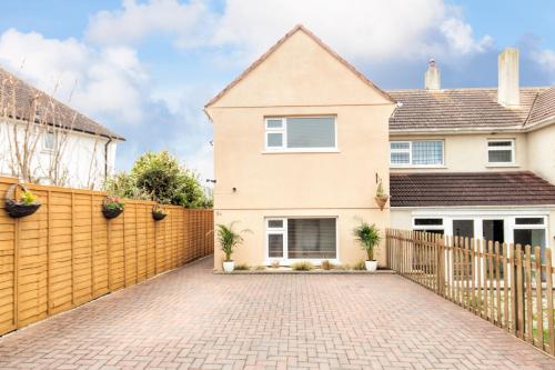 a house with a wooden fence and a driveway at Padstow Bed & Breakfast in Padstow