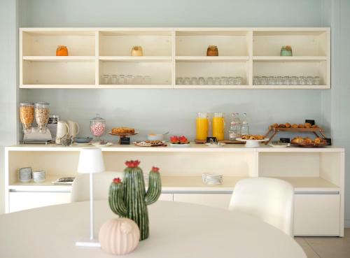 a kitchen with a table with a cactus on it at Hotel Carillon in Baveno