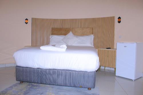 Ein Bett oder Betten in einem Zimmer der Unterkunft Paradise Reho Guesthouse