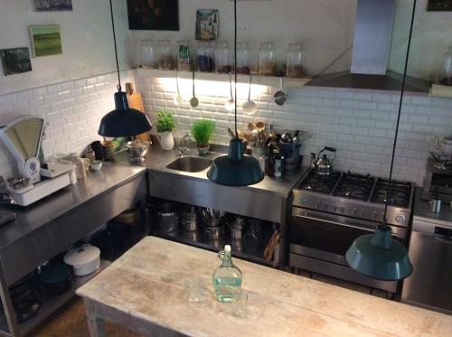 a kitchen with a stove and a counter top at The Secret Garden in Herentals