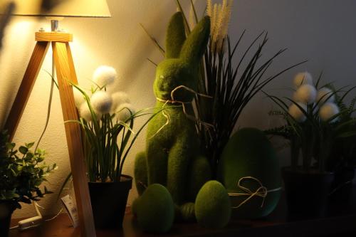 a stuffed rabbit sitting on a table next to plants at Willa Stożek, 50 m od term i wyciągów narciarskich in Białka Tatrzanska