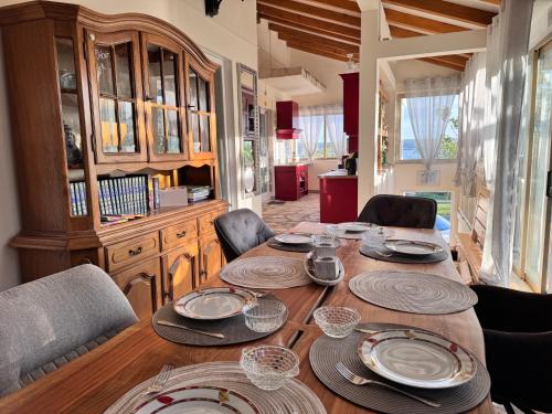 a dining room table with chairs and plates on it at Ferienhaus in Kroatien für 9 Personen in Maslenica