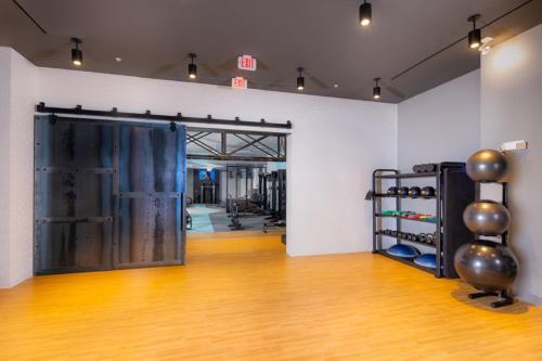 a gym with a large door and a wooden floor at Spacious Stay in Alexandria Easy Access to DC in Alexandria
