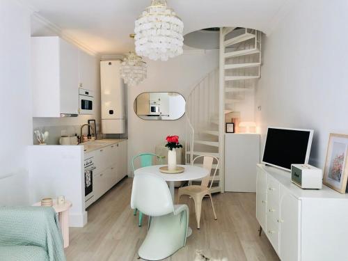 a kitchen and dining room with a table and chairs at Villa Mini Romy with outdoor area in Parmain