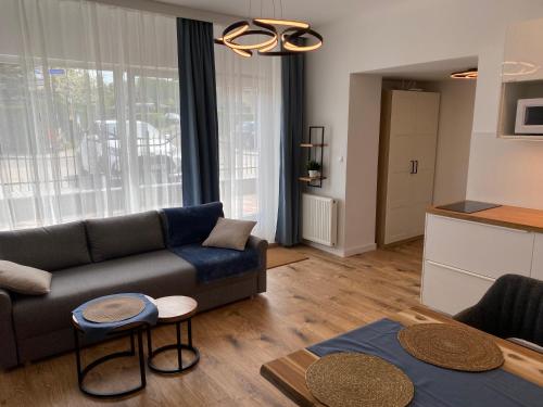 a living room with a couch and a table at Apartamenty Toronto in Kudowa-Zdrój