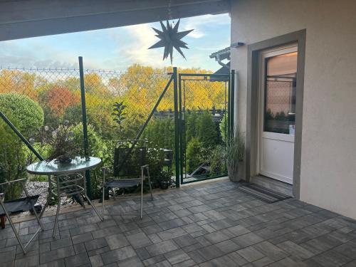 a patio with a table and chairs and a sliding glass door at Inkognito in Teplice