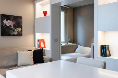 a living room with a couch and a chair at Residence Oliveto in Ceriale