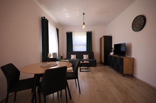 a living room with a table and a couch at Apartamenty Polna Przystań in Stronie Śląskie
