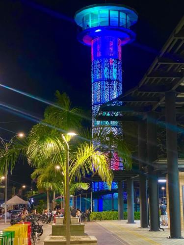 a tower lit up in blue and red at night at Apartamento Encanto in Puerto Triunfo