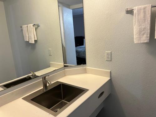 a bathroom with a sink and a mirror at Studio 6 Phoenix, AZ Midtown in Phoenix