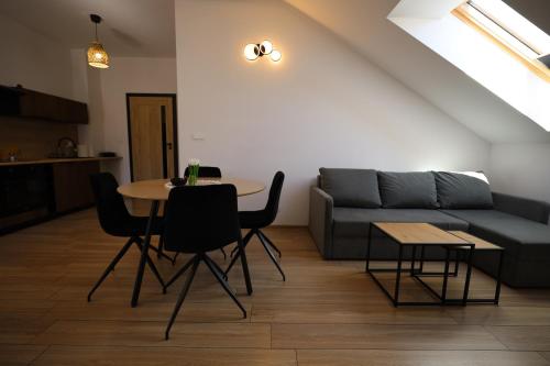 a living room with a couch and a table at Apartamenty Polna Przystań in Stronie Śląskie