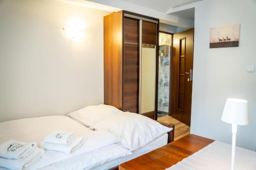a bedroom with two beds with towels on them at Pokoje Gościnne Na Szlaku in Krościenko