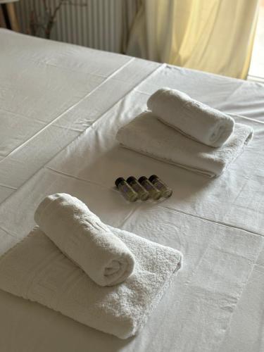 a group of towels on top of a bed at Villa Oneiropagida in Preveza
