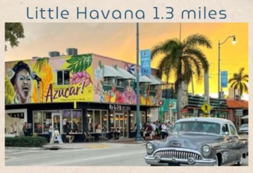 an old car driving down a street in a city at 5 Star Feel in Miami Prime Location in Miami
