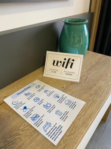 a sign sitting on a table next to a vase at Luxury studio room - in Courtyard Holiday Resort in İskele