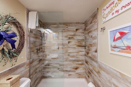 a bathroom with a shower with a glass door at Surfside II Unit 309 in South Padre Island