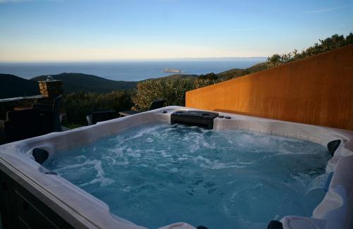 a jacuzzi tub sitting on top of a building at Hotel Le Saint Jean in Ersa