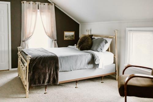 a bedroom with a bed and a window at Spacious Home Near Lake MI w Fire Pit in Sheboygan