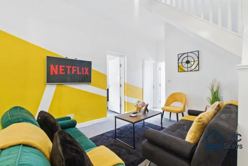 a living room with a couch and a tv at West House 4-bed Perfect for Contractors, Groups and Families in West Bromwich