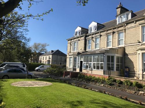 a house with a lawn in front of it at The Clifton Hotel Newcastle in Newcastle upon Tyne