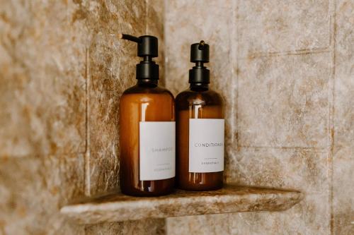 two bottles of soap sitting on a shelf at Spacious Home Near Lake MI w Fire Pit in Sheboygan