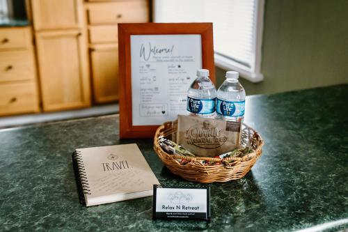 a basket of water bottles and a sign on a counter at Spacious Home Near Lake MI w Fire Pit in Sheboygan