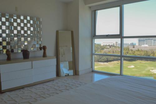 a bedroom with a bed and a large window at Beautiful Seibal Stay w Vidanta Resort Access in Nuevo Vallarta 