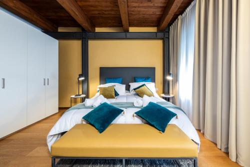 a large bedroom with a large bed with blue pillows at Suite Deluxe in Palazzo Storico - Centro Sassari - Appartamento Sassari in Sassari