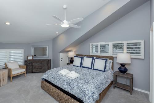 a bedroom with a large bed with blue pillows at 1120 Duneside Villa by Akers Ellis Rentals in Kiawah Island