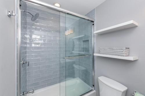 a glass shower in a bathroom with a toilet at 1120 Duneside Villa by Akers Ellis Rentals in Kiawah Island