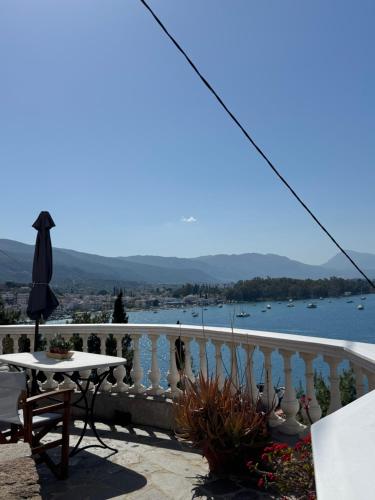 a balcony with a table and a view of the water at Kasteli Suite in Poros
