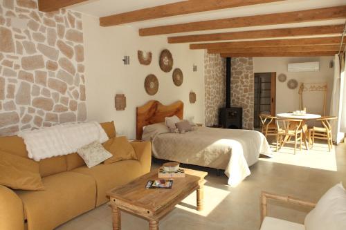 a living room with a bed and a couch at Bella Vista Suit Casas Lacambra in Tolosa