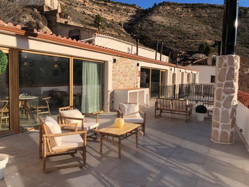 a patio with chairs and a table on a house at Bella Vista Suit Casas Lacambra in Tolosa