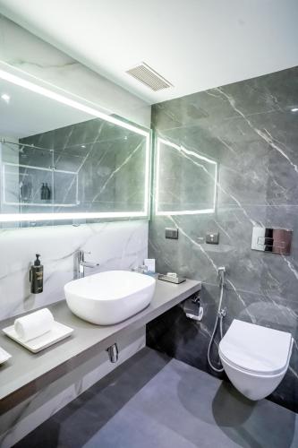 a bathroom with a sink and a toilet at ASTER GRAND BY ZENQ Saket in New Delhi