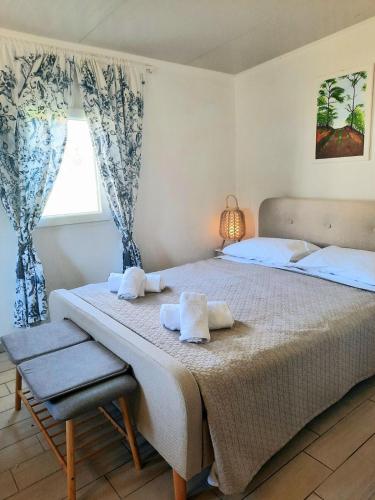 a bedroom with a large bed with towels on it at The Getaway in Sálakos