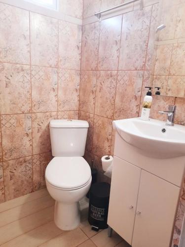 a bathroom with a toilet and a sink at The Getaway in Sálakos