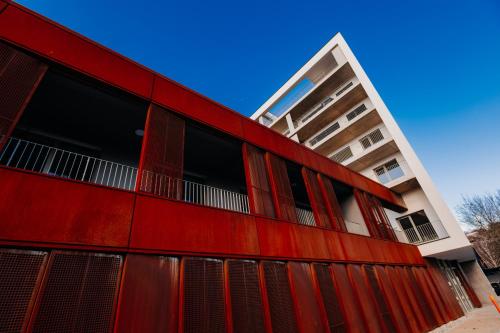 a red building with a white building at Apartmán Blue Wave in Banka
