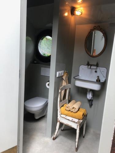 a small bathroom with a sink and a toilet at Houseboat Tante Piet in Amsterdam