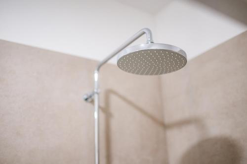 a shower with a shower head in a bathroom at Apartmán Blue Wave in Banka
