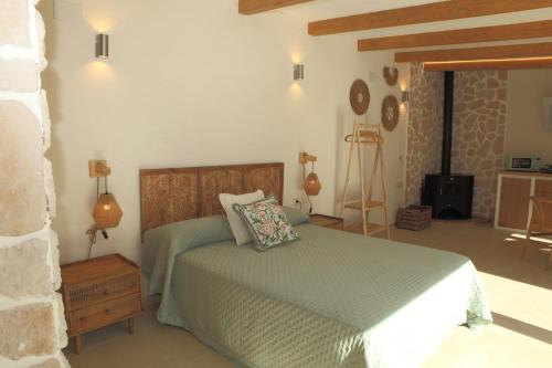 a bedroom with a bed and a stone wall at Paraiso Suit Casas Lacambra in Tolosa